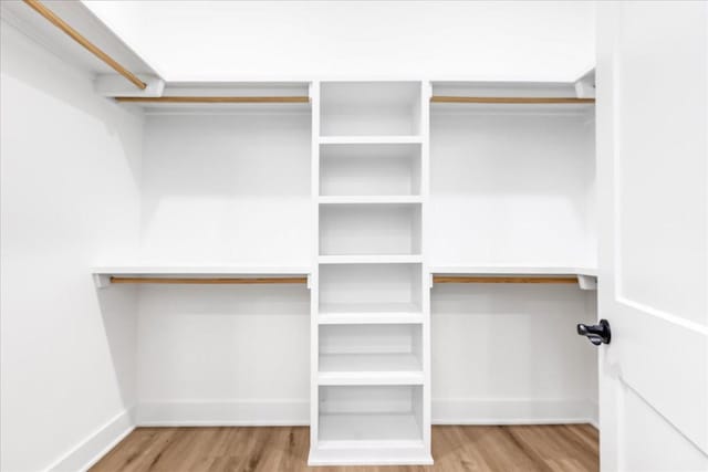 walk in closet featuring wood finished floors