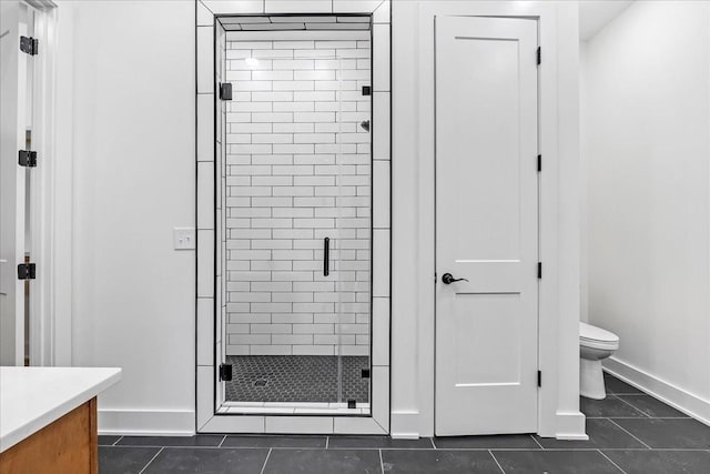 full bathroom with baseboards, toilet, tile patterned floors, and a stall shower