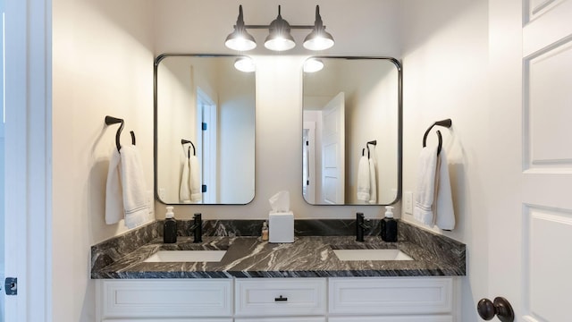 full bathroom featuring double vanity and a sink
