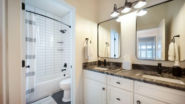 full bathroom featuring shower / bath combination with curtain, toilet, a sink, and double vanity