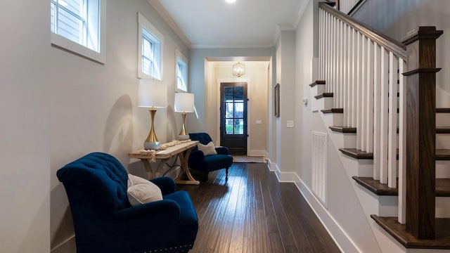 interior space with a healthy amount of sunlight, crown molding, stairs, and visible vents