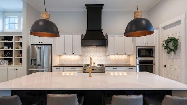 kitchen featuring premium range hood, ornamental molding, stainless steel appliances, and a breakfast bar