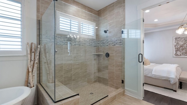 full bath featuring a soaking tub, recessed lighting, wood finished floors, a shower stall, and connected bathroom