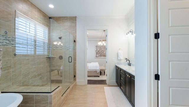 ensuite bathroom with recessed lighting, vanity, ornamental molding, a stall shower, and ensuite bathroom