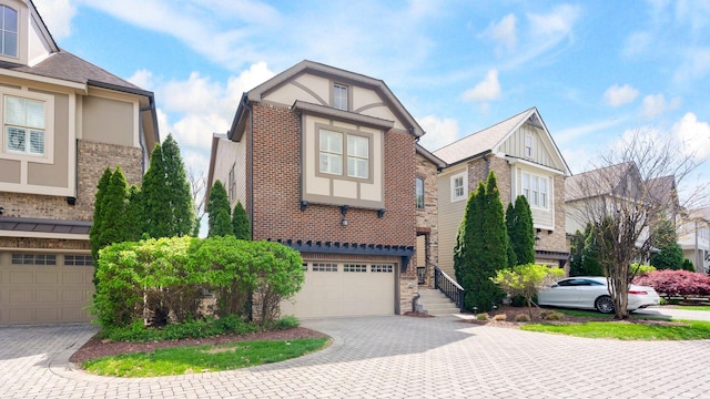 view of front of property with a garage, brick siding, and decorative driveway