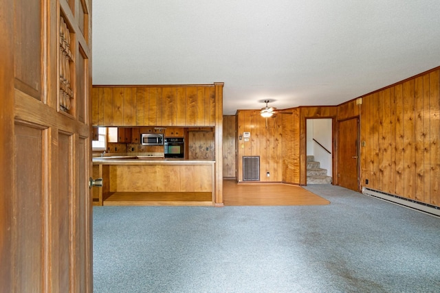 4103 Arno Rd, Franklin, TN 37064 - unfurnished living room with stairway, baseboard heating, wooden walls, ceiling fan, and carpet floors