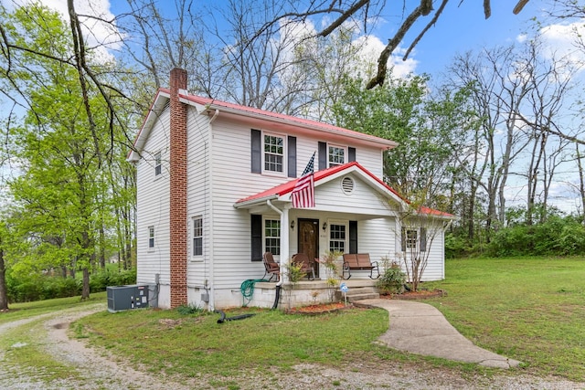 4103 Arno Rd, Franklin, TN 37064 - view of front of property with central air condition unit, a chimney, a front yard, and covered porch