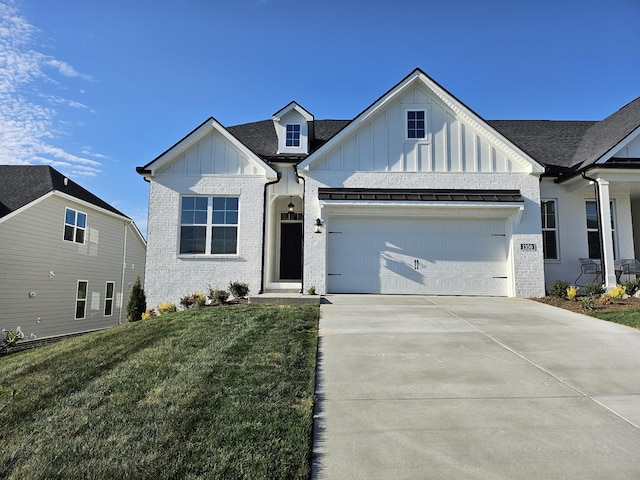 view of front of home with board and batten siding, a front yard, a garage, and concrete driveway