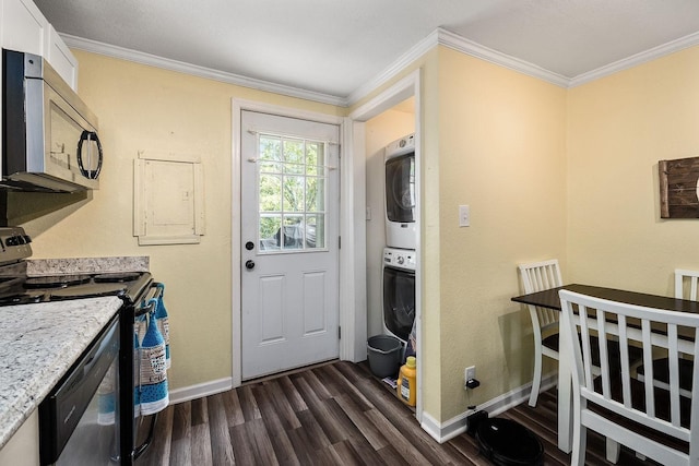 212 Mullican St, Mcminnville, TN 37110 - washroom with dark wood-style floors, baseboards, stacked washer and dryer, and laundry area