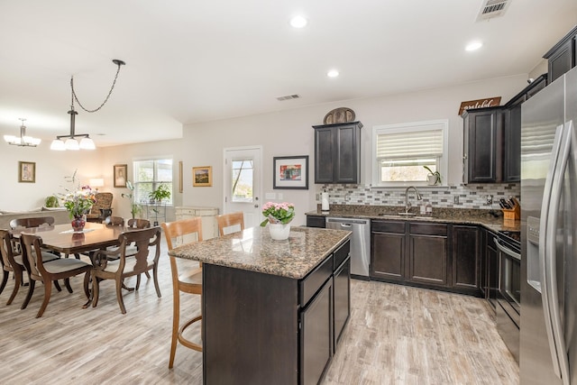 1517 Rockwood Ln, Lebanon, TN 37087 - kitchen featuring light wood-type flooring, visible vents, stainless steel appliances, and dark stone countertops