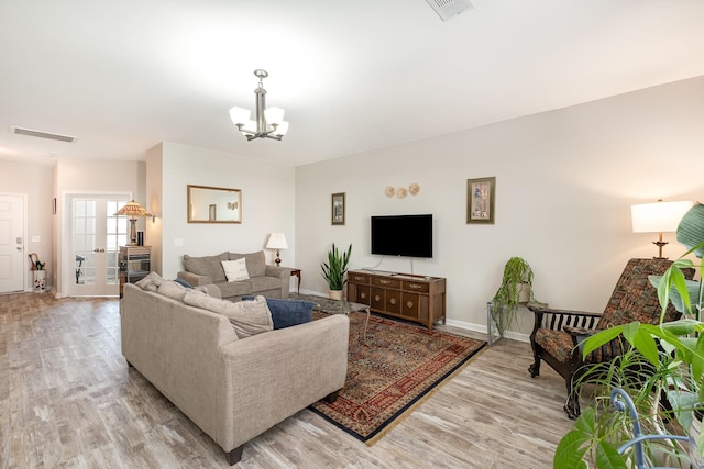 1517 Rockwood Ln, Lebanon, TN 37087 - living area featuring light wood finished floors, baseboards, visible vents, and an inviting chandelier
