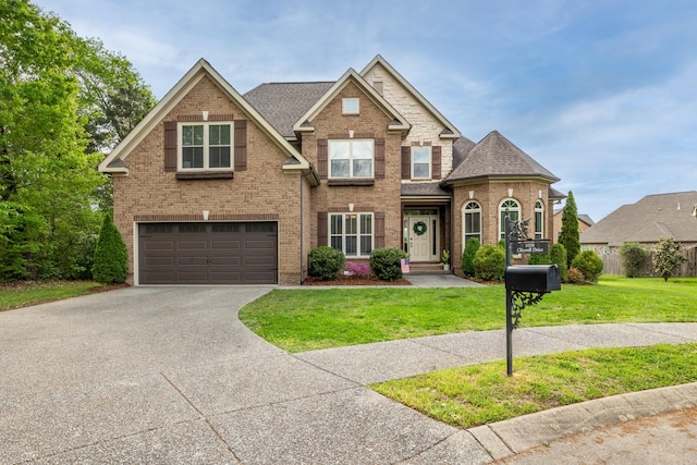 1026 Claymill Dr, Spring Hill, TN 37174 - view of front of home featuring an attached garage, driveway, brick siding, and a front yard
