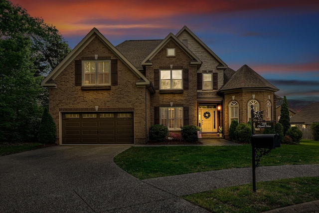 1026 Claymill Dr, Spring Hill, TN 37174 - traditional home featuring brick siding, a yard, an attached garage, and concrete driveway