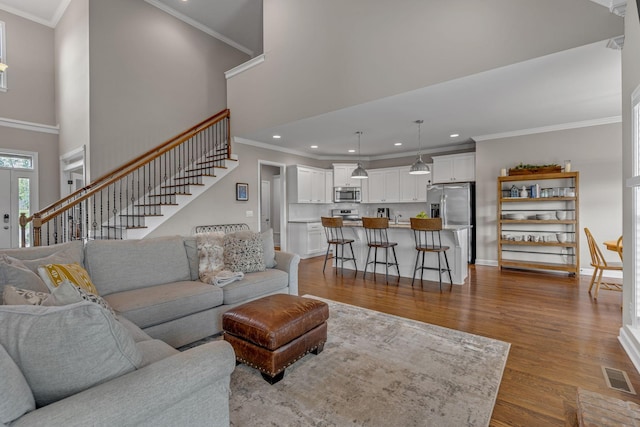 1026 Claymill Dr, Spring Hill, TN 37174 - living room featuring dark wood finished floors, stairway, visible vents, and a high ceiling