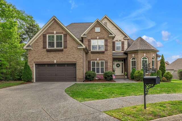 1026 Claymill Dr, Spring Hill, TN 37174 - view of front of property featuring a front lawn, roof with shingles, driveway, brick siding, and a garage