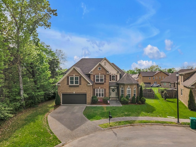 1026 Claymill Dr, Spring Hill, TN 37174 - view of front facade with a garage, driveway, fence, a front yard, and brick siding
