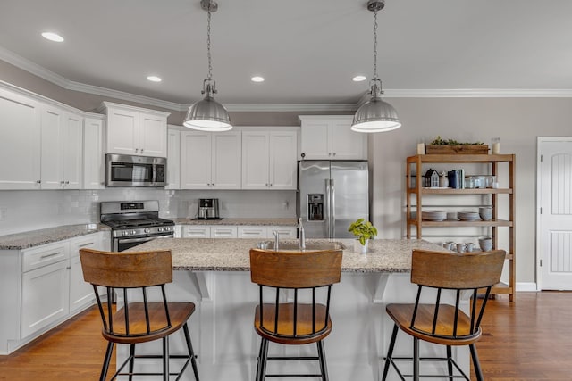 1026 Claymill Dr, Spring Hill, TN 37174 - kitchen featuring ornamental molding, appliances with stainless steel finishes, tasteful backsplash, and white cabinetry