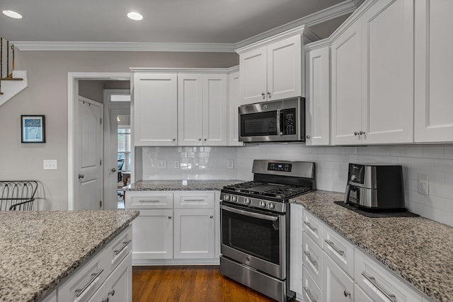 1026 Claymill Dr, Spring Hill, TN 37174 - kitchen with white cabinets, stainless steel appliances, dark wood-style flooring, and crown molding
