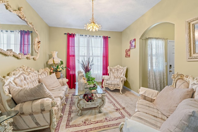 3367 William Bailey Dr, Nashville, TN 37207 - living area with arched walkways, carpet floors, baseboards, and a notable chandelier