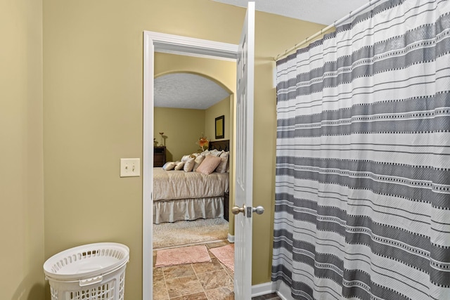 3367 William Bailey Dr, Nashville, TN 37207 - full bathroom featuring stone finish flooring, ensuite bathroom, a textured ceiling, and curtained shower