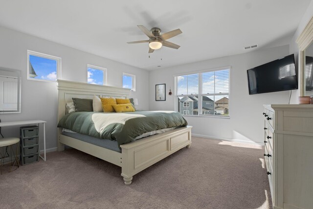 bedroom with baseboards, visible vents, carpet floors, and ceiling fan