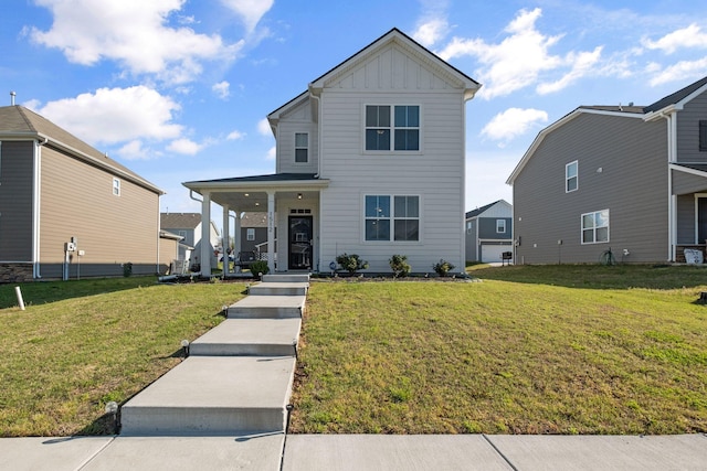 traditional-style home with board and batten siding, a front yard, and covered porch