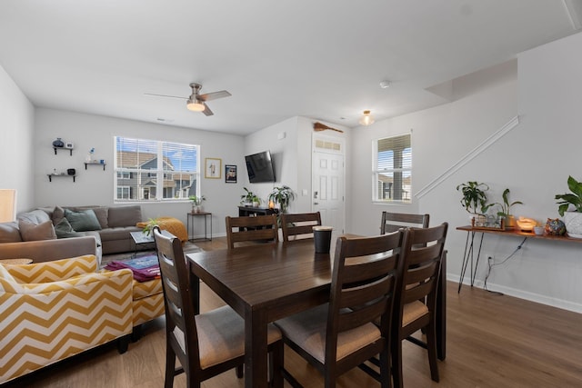 dining room with wood finished floors, baseboards, and plenty of natural light