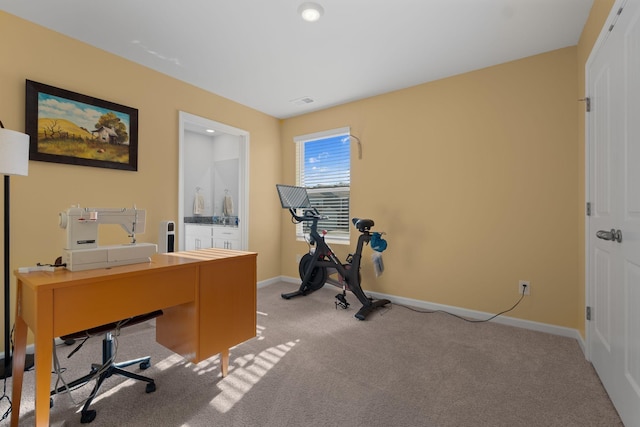 home office featuring light colored carpet and baseboards