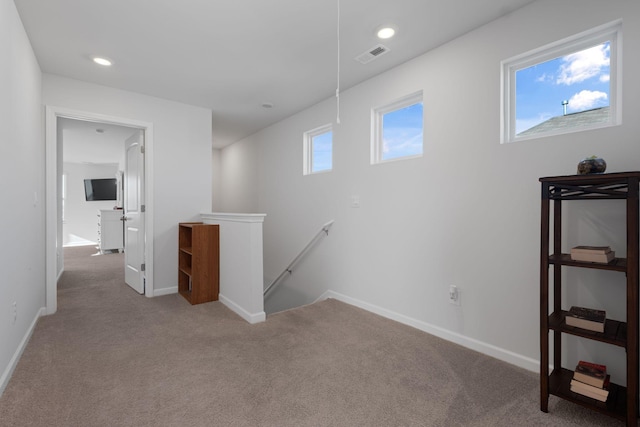 interior space with baseboards, visible vents, carpet floors, and recessed lighting
