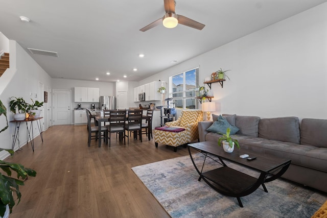living room with visible vents, recessed lighting, ceiling fan, and dark wood finished floors