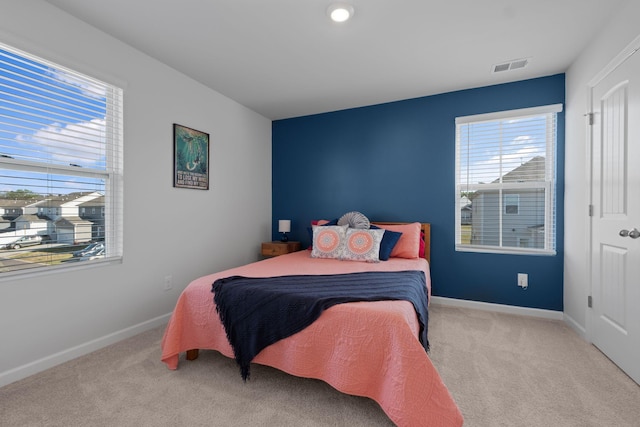carpeted bedroom with baseboards and visible vents