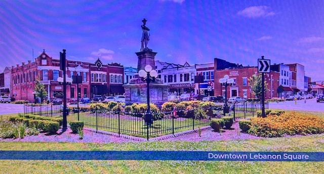 view of home's community featuring fence