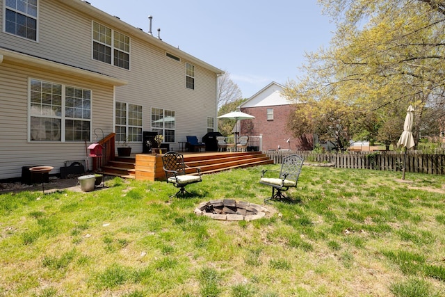 304 Hay Market Ct, Franklin, TN 37067 - rear view of house with a fire pit, a yard, a wooden deck, and fence