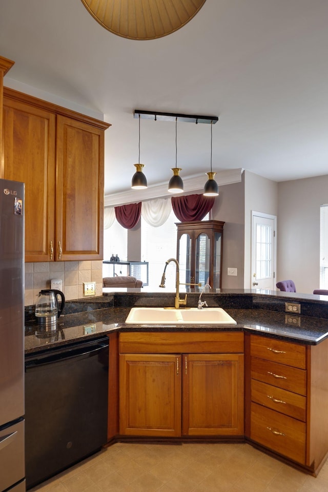 304 Hay Market Ct, Franklin, TN 37067 - kitchen with a sink, track lighting, freestanding refrigerator, brown cabinetry, and dishwasher