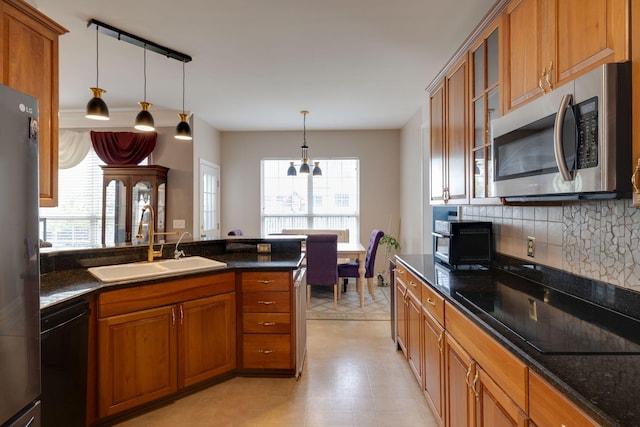 304 Hay Market Ct, Franklin, TN 37067 - kitchen featuring brown cabinets, a sink, glass insert cabinets, black appliances, and tasteful backsplash