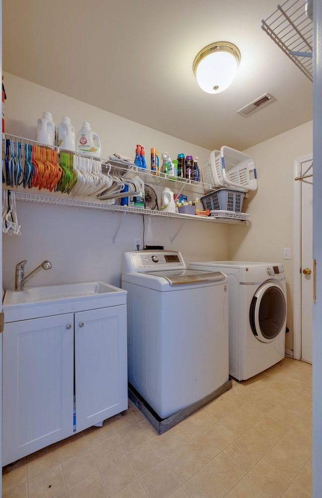 304 Hay Market Ct, Franklin, TN 37067 - laundry room with cabinet space, visible vents, washing machine and clothes dryer, and a sink