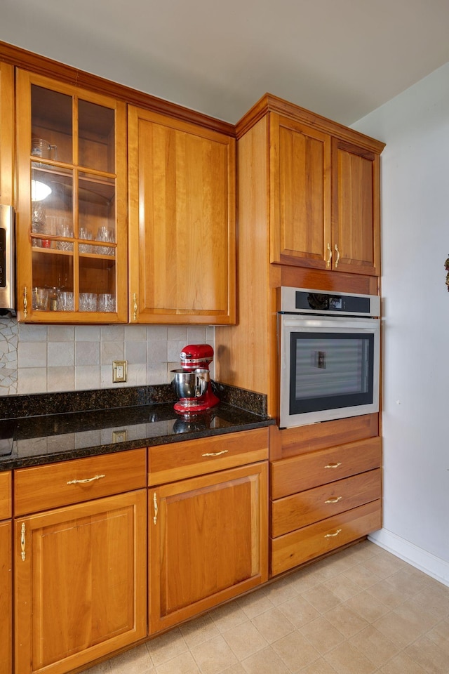 304 Hay Market Ct, Franklin, TN 37067 - kitchen featuring stainless steel oven, brown cabinetry, and glass insert cabinets