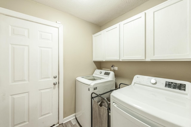 327 Arabian Ln, Springfield, TN 37172 - washroom featuring light wood-style flooring, baseboards, washer and clothes dryer, and cabinet space