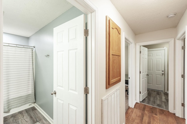 327 Arabian Ln, Springfield, TN 37172 - hall with dark wood finished floors, a textured ceiling, baseboards, and visible vents