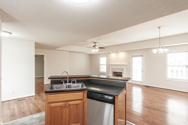 327 Arabian Ln, Springfield, TN 37172 - kitchen featuring dark countertops, a sink, open floor plan, dishwasher, and light wood-style flooring
