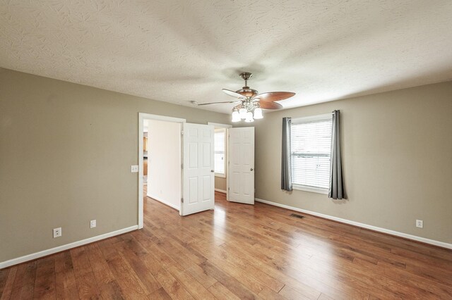 327 Arabian Ln, Springfield, TN 37172 - unfurnished bedroom featuring visible vents, baseboards, wood finished floors, and ceiling fan