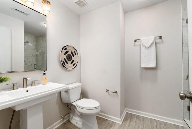 full bath with visible vents, wood finished floors, a shower stall, and toilet