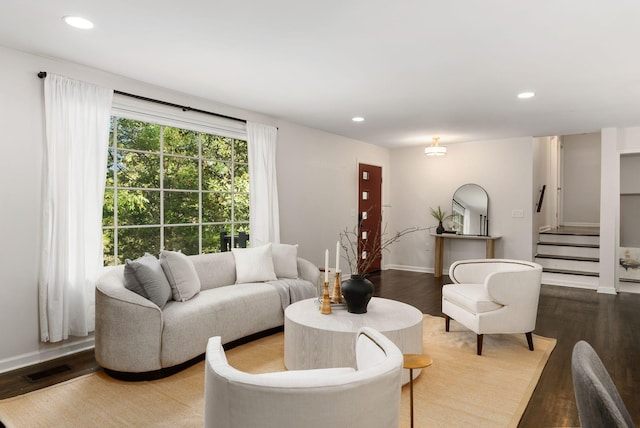 living room with baseboards, wood finished floors, recessed lighting, and stairway