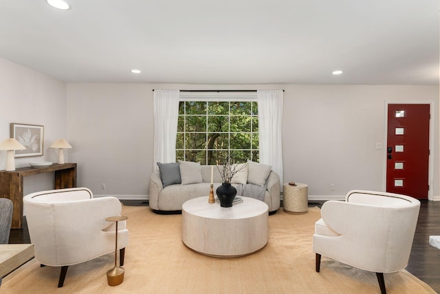 living area with recessed lighting, wood finished floors, and baseboards