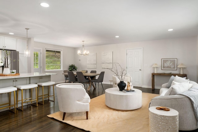 living area featuring dark wood finished floors, an inviting chandelier, baseboards, and recessed lighting