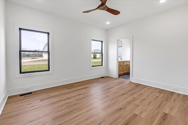 unfurnished room featuring light wood-type flooring, ceiling fan, baseboards, visible vents, and recessed lighting