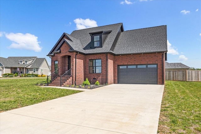 view of front facade featuring fence, brick siding, a front yard, and concrete driveway