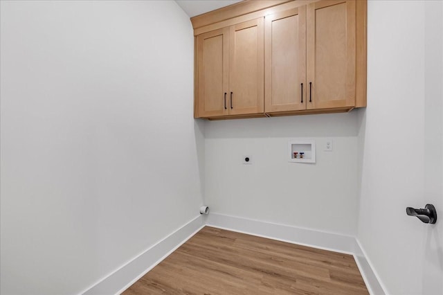 clothes washing area with light wood-style flooring, baseboards, washer hookup, cabinet space, and electric dryer hookup