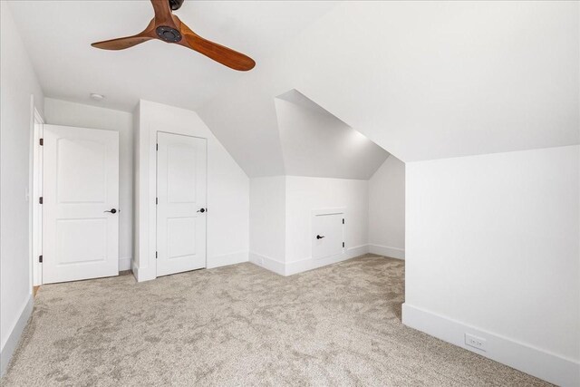 bonus room featuring baseboards, vaulted ceiling, carpet flooring, and a ceiling fan