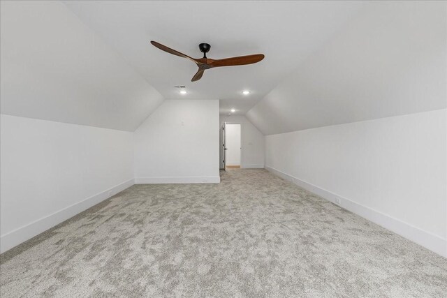 bonus room featuring lofted ceiling, carpet floors, and baseboards